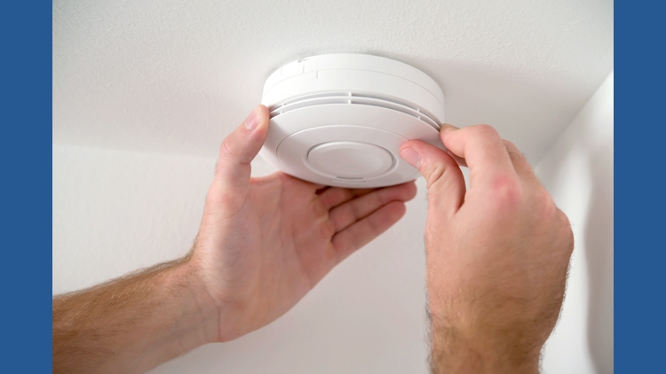 Family testing smoke alarms together in Cleveland